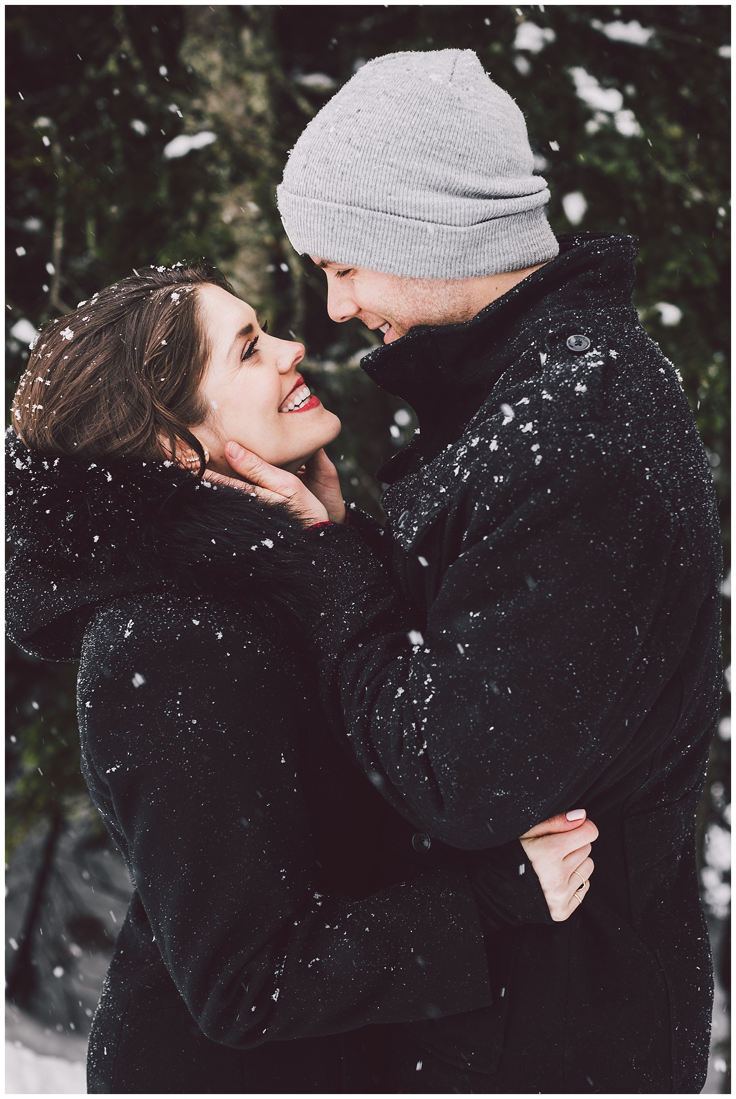 Smiling in the snow during their engagement photos