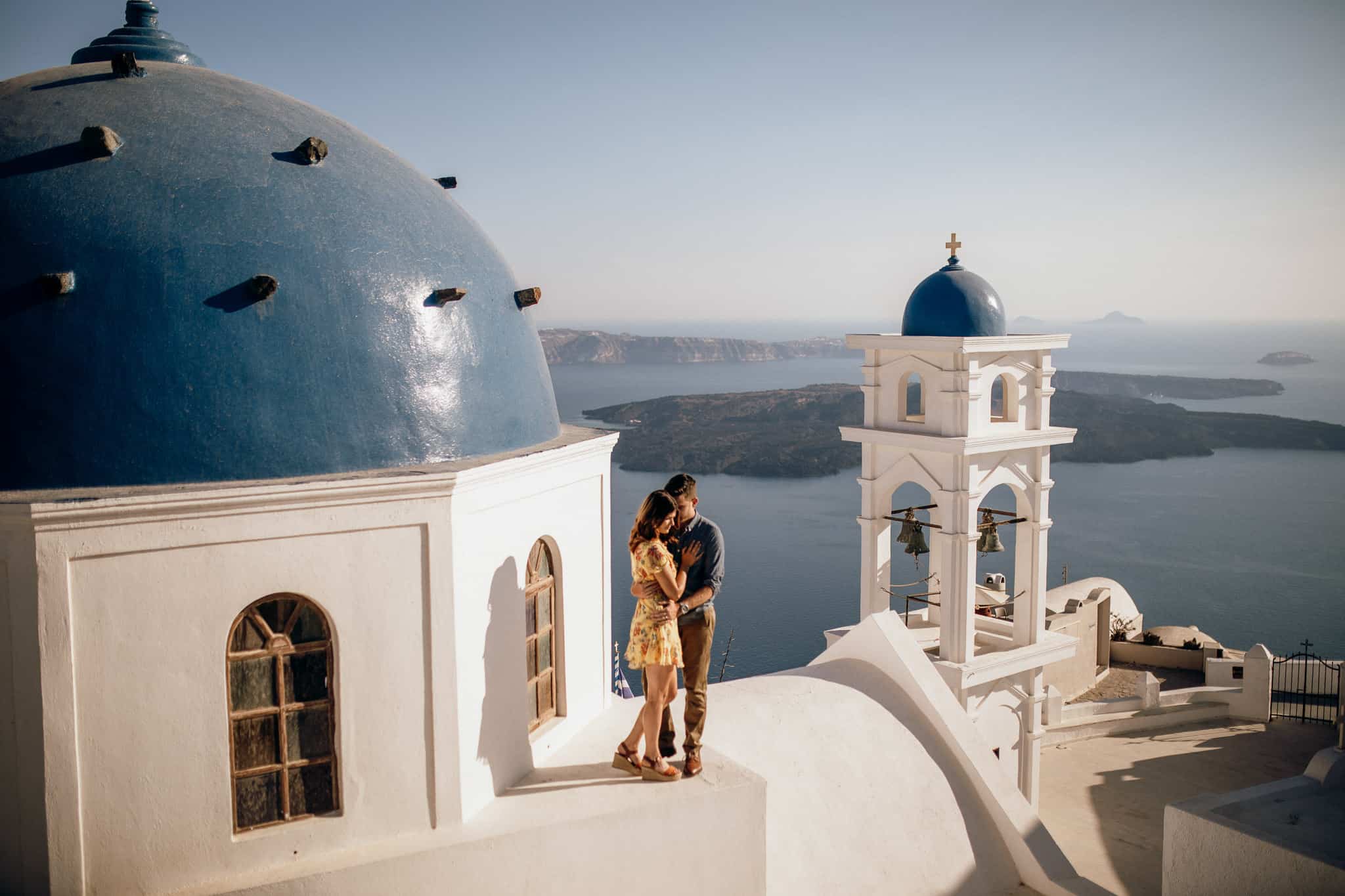 Kyle & Haley Goldie in Imerovigli, Santorini on top of a blue dome church