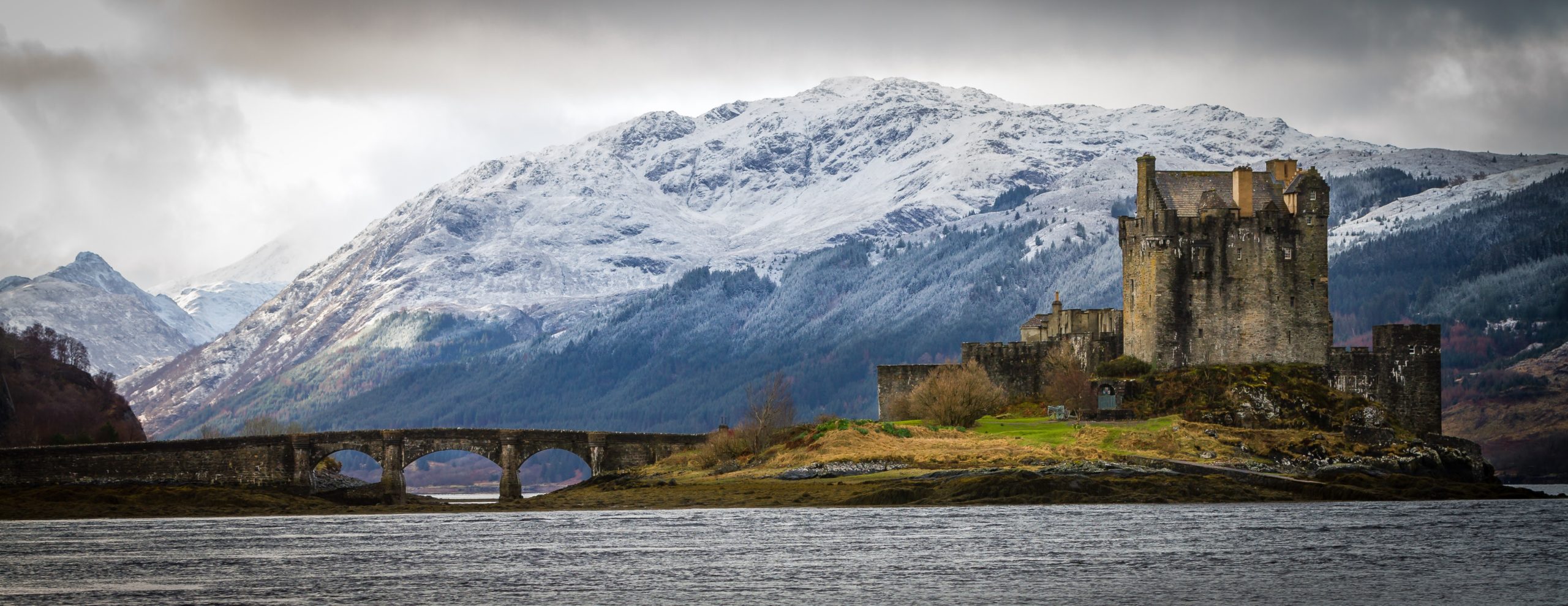 A landscape photograph of the Eilean Donan Castle wedding venue in the Scottish Highlands.